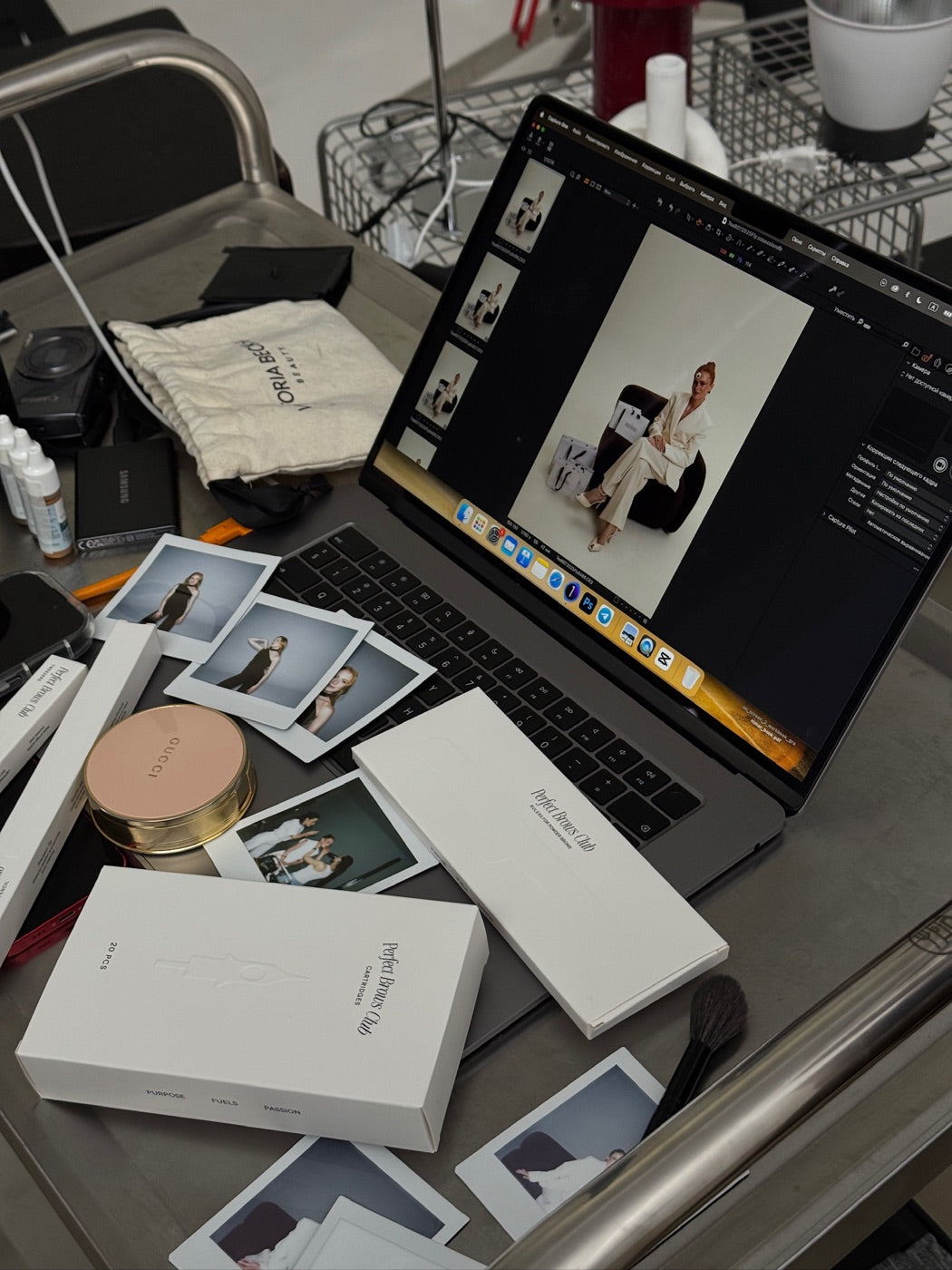 Behind the scenes at a Perfect Brows Club photoshoot, with product packaging, portraits and a laptop
